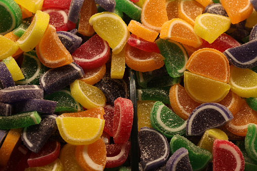 An assortment of fruit flavored hard candy on a white background