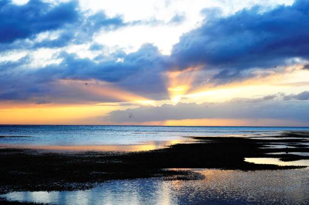 istock a body of water with the sun setting in the background 1490885714
