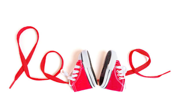 istock Word LOVE Made from Tiny Shoes and Lace on White 1490885816