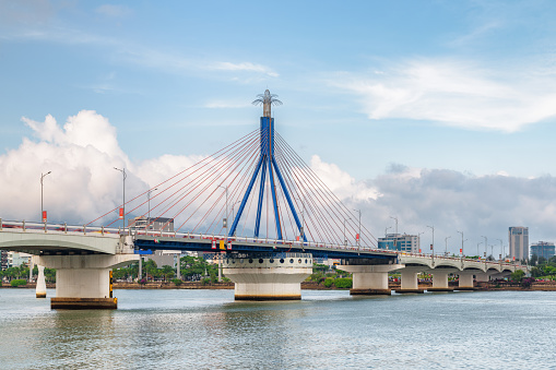 Beautiful view of the Han River Bridge (Cau Song Han) over the Han River at downtown of Da Nang (Danang), Vietnam. Scenic cityscape. The Han River Bridge is a popular tourist attraction of Asia.