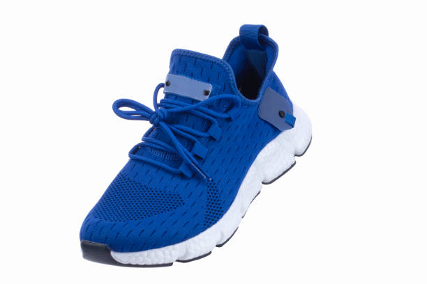 istock Blue sneaker made of fabric with a white sole on a white shoe. 1490891484