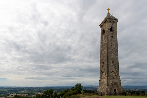 Low angle view of Tyndale Monument at North Nibley, Gloucestershire, UK, built in honor of William Tyndale overlooking the Cotswold Edge with footpath Cotswold Way passing the monument