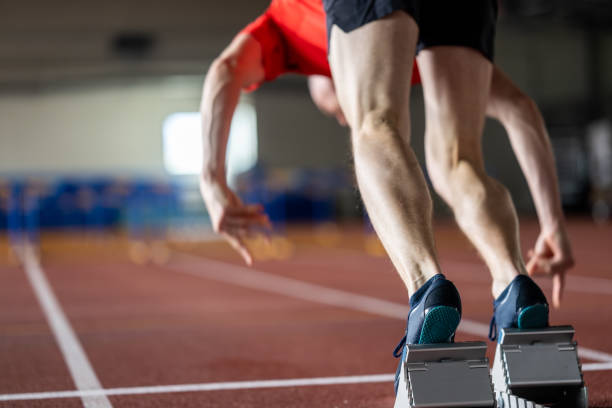 istock Athlete running to hurdles at stadium 1490896022