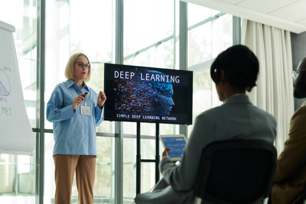 istock Confident blond mature woman in smart casualwear making presentation 1490896253