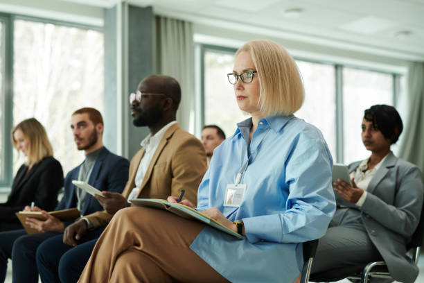 istock Blond serious businesswoman with open notebook on her knees 1490896277