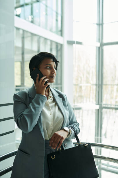 istock Young confident female agent talking to client on smartphone 1490896373