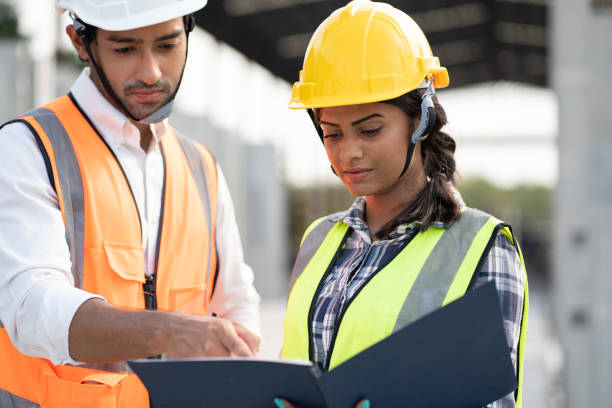 istock India engineer woman and Asia engineer man working with document at precast site work 1490896581