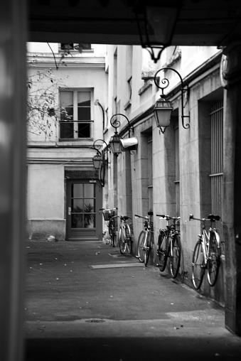 Lifestyle photograph depicting typical Parisian ourtyard with bicycles.