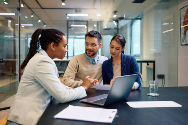 istock Young couple going through paperwork with financial advisor during the meeting. 1490897794