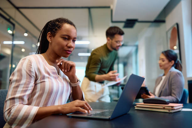 istock Black female entrepreneur working on laptop in the office. 1490897961