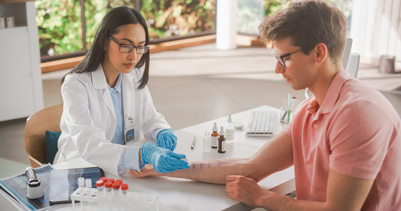 Female Healthcare Professional at Work in Hospital Office. Doctor Applying Different Solutions with Food Allergens on Patient's Forearm. Immunologist Diagnosing any Immediate Allergic Skin Reactions