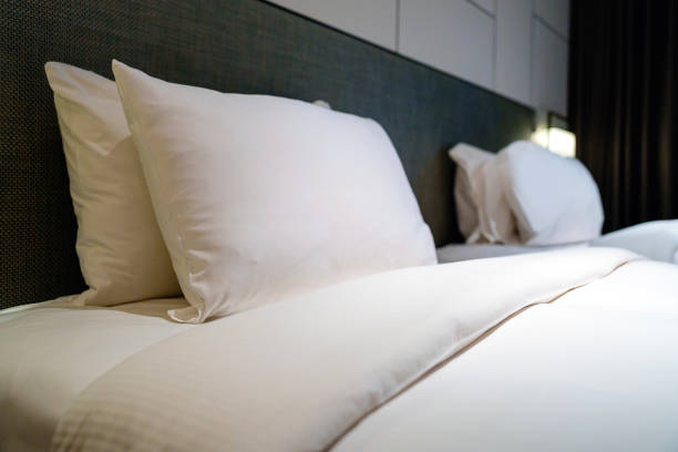 istock A clean and comfortable bedroom interior features white pillows neatly arranged on the bed. 1490900296