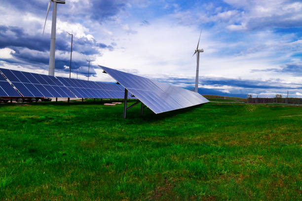 istock Blue solar panels power stations and windmills against the blue sky. Alternative renewable clean green power, Renewable energy 1490900442