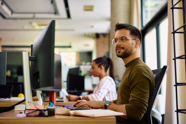 istock Young programmer working on desktop PC in the office of a software company. 1490901280