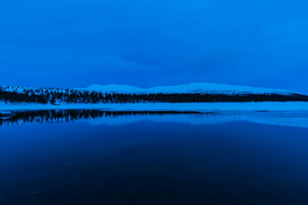 Reflection of snow covered mountain