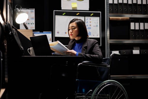 istock Accountant in wheelchair checking profit 1490904477