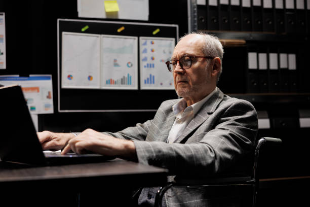 istock Accountant in wheelchair at office desk 1490904988