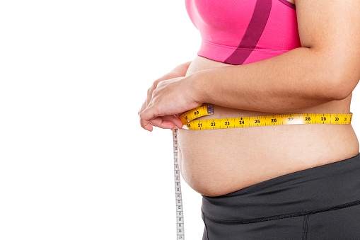 Fat woman measuring her stomach isolated on white background. Overweight, Obesity. Woman diet lifestyle concept