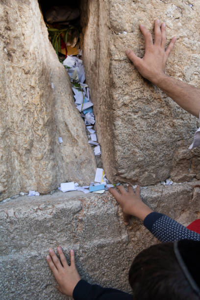 istock Worshippers' hands on the Western Wall 1490906367