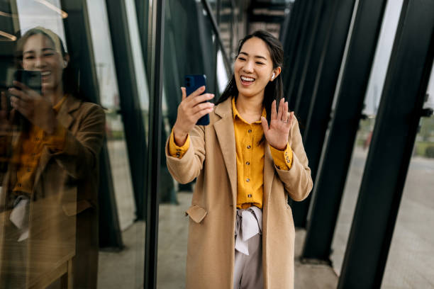 istock Businesswoman Video Calling with Wireless Earbuds 1490907060
