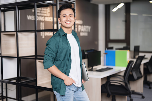 Photo of young Asian businessman working at office