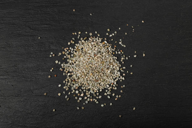 istock Crushed Quartz Pile, White Stone Pieces, Grit Sand, Decorative Rocks Texture on Black Background 1490911089