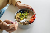 Woman holding smoothie in a bowl