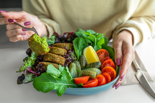 Falafel from chickpeas with lettuce salad, tomatoes, lemon slices