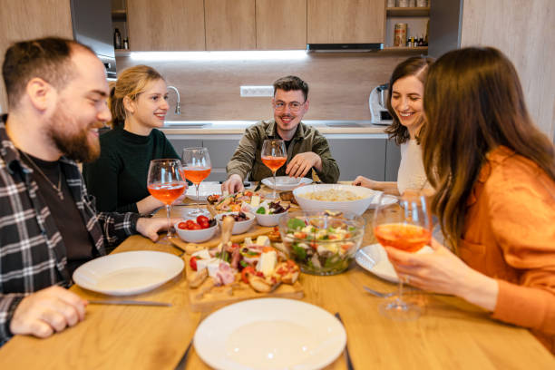 istock Dinner with friends in a modern home. Smiles and liveliness. 1490914402