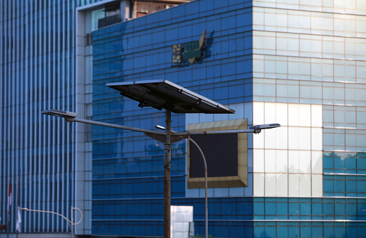 Solar street lamp with office building background
