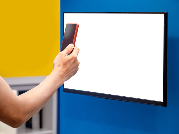 istock Male customer using smartphone scanning QR code on Interactive digital monitor for searching goods information in department store. Blank white screen for mockup 1490915205