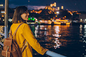 A young woman looks around Istanbul at night