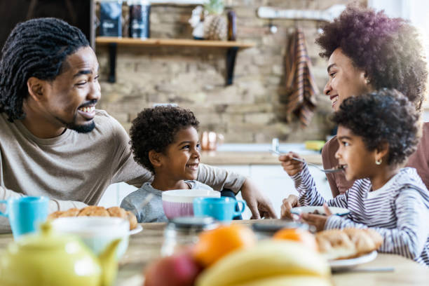 istock Happy black family talking while having breakfast in the morning. 1490916241