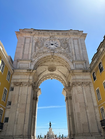 Rua de Augusta arch in the centre of Lisbon , framing a view of the riverside