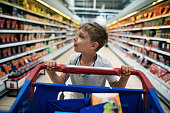 Portrait of a little boy doing shopping in a supermarket