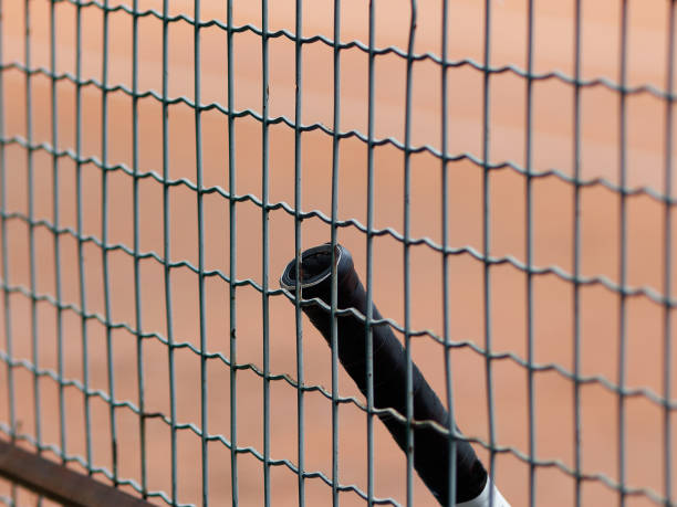 istock Close-up tennis racket  placed on court ground. 1490916635