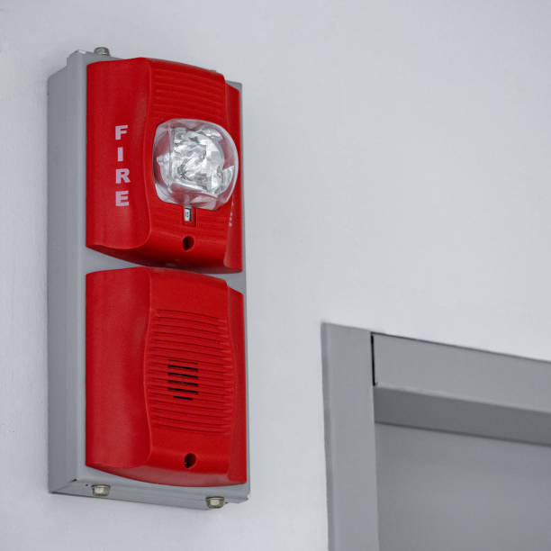 istock Fire alarm with built in emergency strobe light and sounder installed on the wall in public building. 1490917732