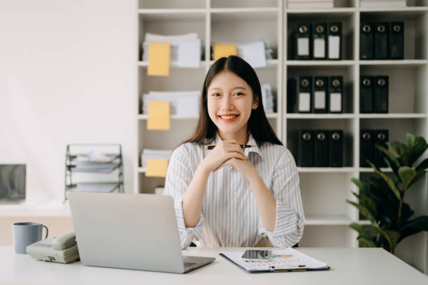 istock Asian businesswoman working in the office with working notepad, tablet and laptop documents in office 1490919233