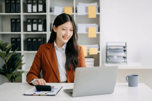 istock Asian businesswoman working in the office with working notepad, tablet and laptop documents in office 1490919273