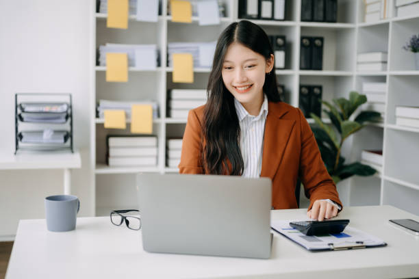 istock Asian businesswoman working in the office with working notepad, tablet and laptop documents in office 1490919280