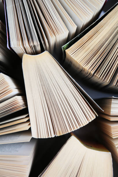 istock Collection of different books on white shelf, above view 1490921397