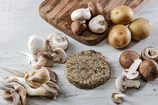 Shiitake mushrooms on the wooden background.