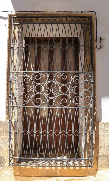 Photo of Window with forged metal details and colorful facades