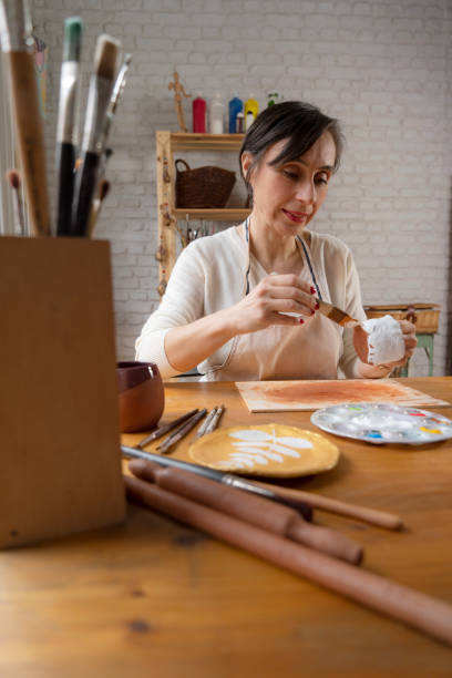 istock Woman painting a pottery 1490925326