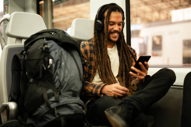 istock Handsome young man traveling by a train. 1490926018