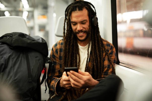 istock Handsome young man traveling by a train. 1490926043
