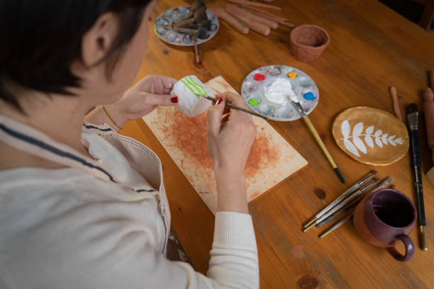 istock Woman painting a pottery 1490927012
