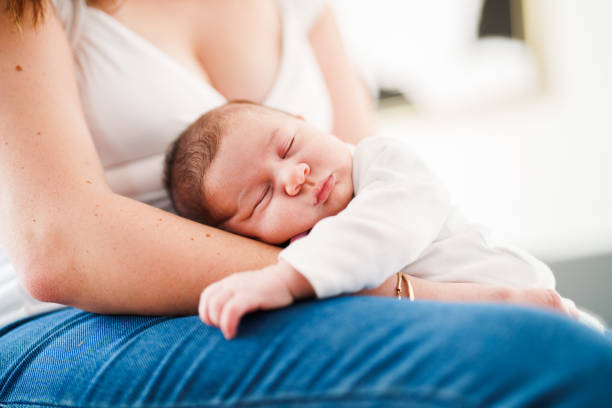 istock Mother putting her baby to sleep on her lap 1490927170