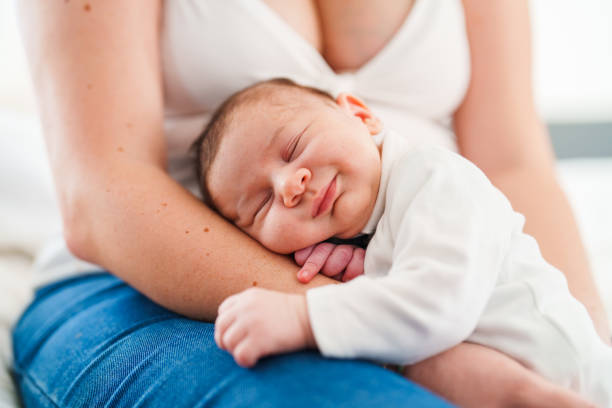 istock Mother putting her baby to sleep on her lap 1490927218