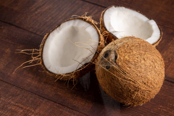istock Whole coconut and pieces of coconut on the table. 1490927529